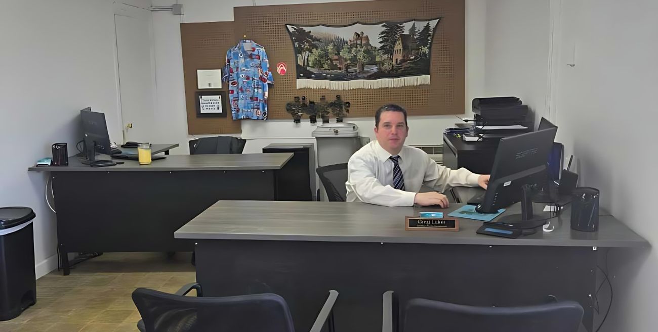 Greg Luker at his desk inside the office